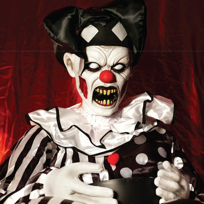 Close up of the clown face with white eyes and yellow teeth